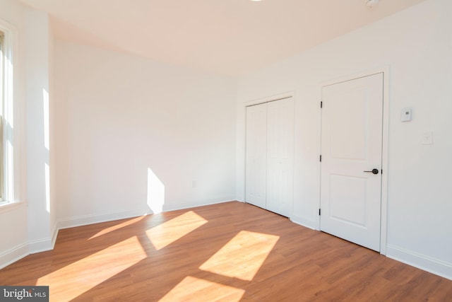 unfurnished bedroom with hardwood / wood-style flooring