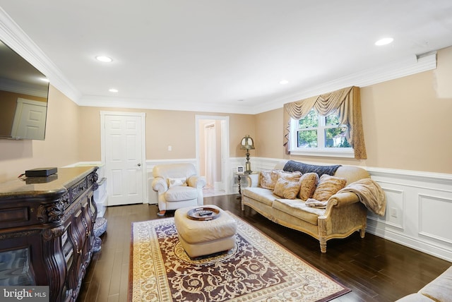 living room featuring dark hardwood / wood-style flooring and ornamental molding