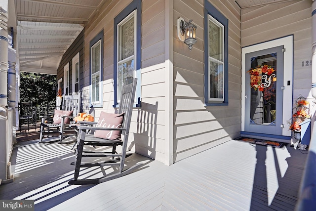 wooden terrace with a porch