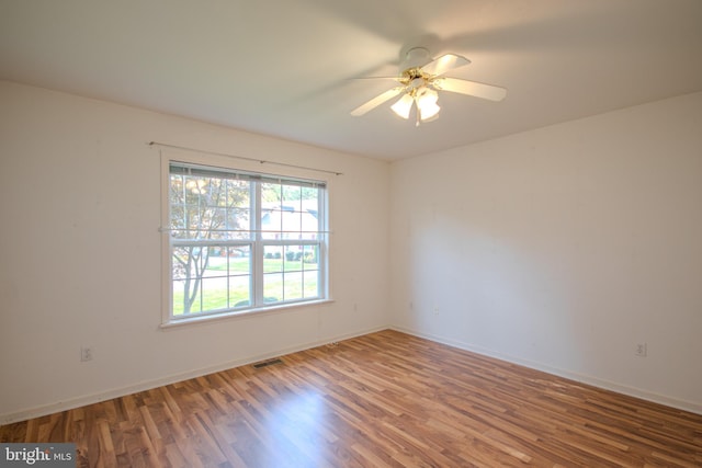 spare room with wood-type flooring and ceiling fan