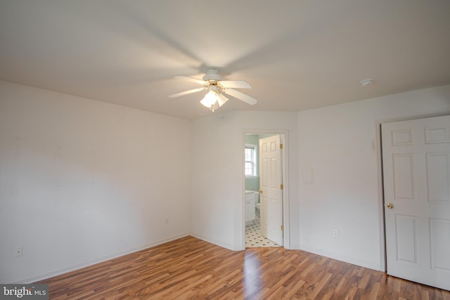 unfurnished room featuring light wood-type flooring and ceiling fan