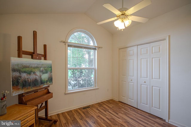 bedroom with hardwood / wood-style flooring, ceiling fan, vaulted ceiling, and a closet