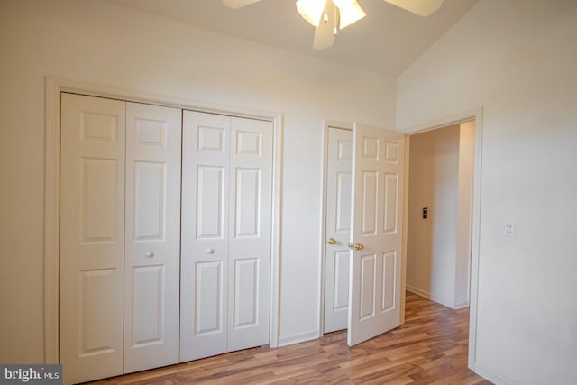 unfurnished bedroom featuring light wood-type flooring, vaulted ceiling, and ceiling fan