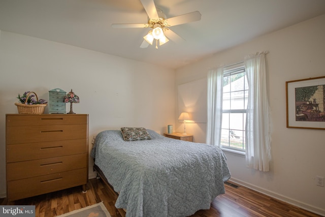 bedroom with dark hardwood / wood-style flooring and ceiling fan