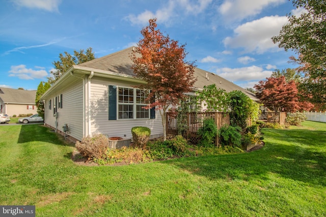 view of side of home with a lawn