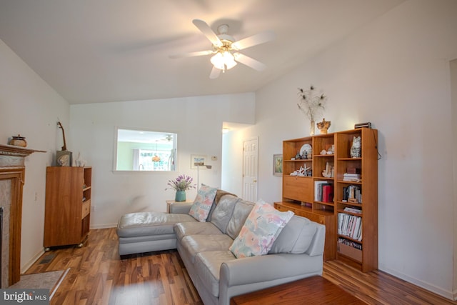 living room featuring lofted ceiling, hardwood / wood-style floors, and ceiling fan