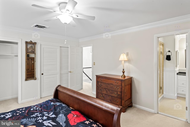 carpeted bedroom with ornamental molding and ceiling fan