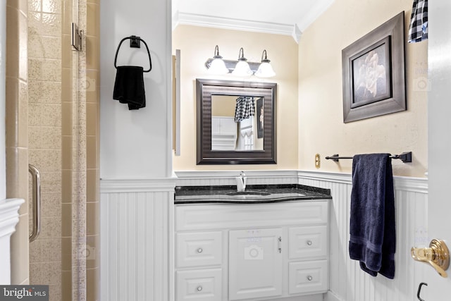 bathroom featuring vanity, ornamental molding, and a shower