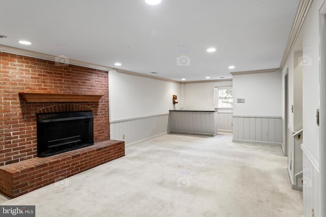 unfurnished living room featuring crown molding, carpet, and a brick fireplace