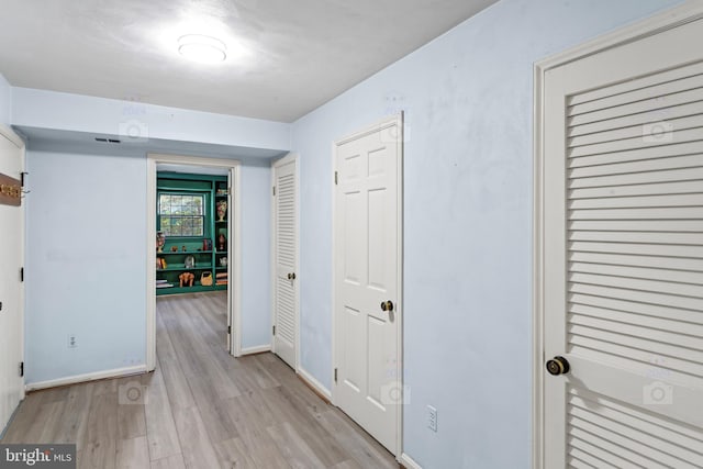 hall with light hardwood / wood-style flooring