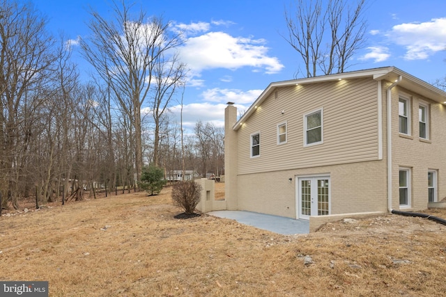 view of side of home featuring french doors and a patio