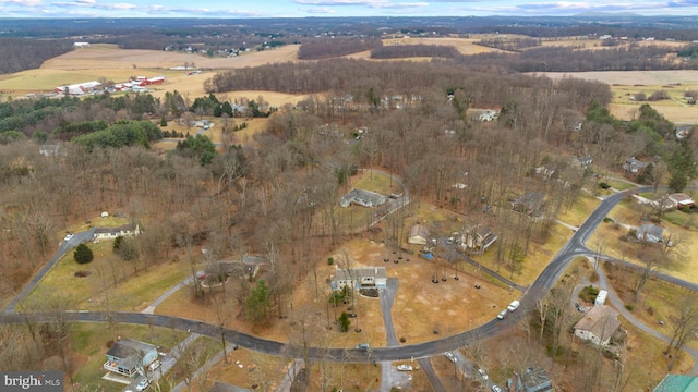 birds eye view of property with a rural view