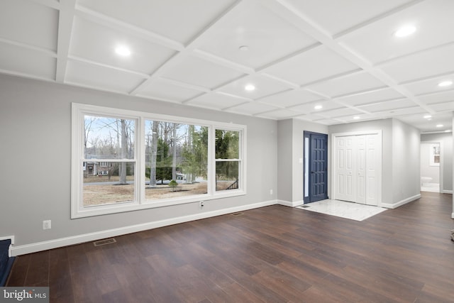 unfurnished living room with plenty of natural light and coffered ceiling