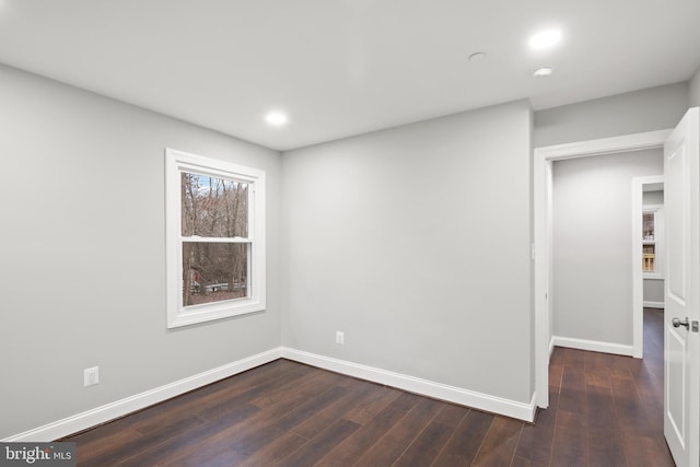 empty room featuring dark wood-type flooring