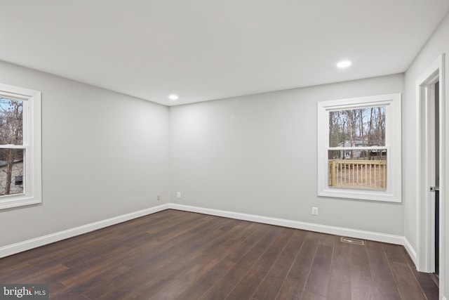 unfurnished room with dark hardwood / wood-style floors