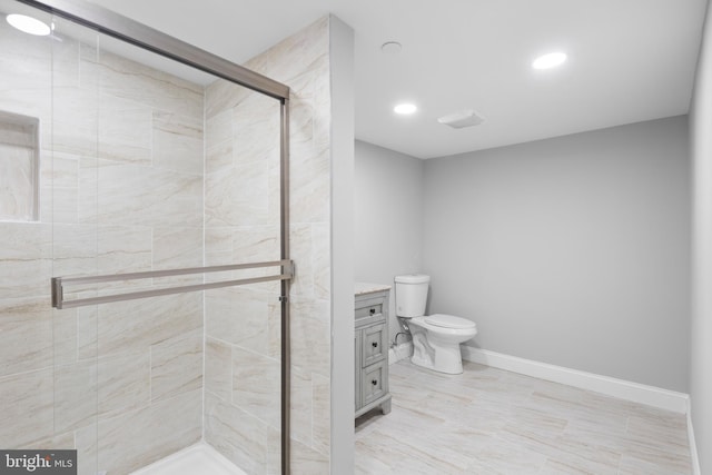 bathroom with vanity, toilet, and an enclosed shower