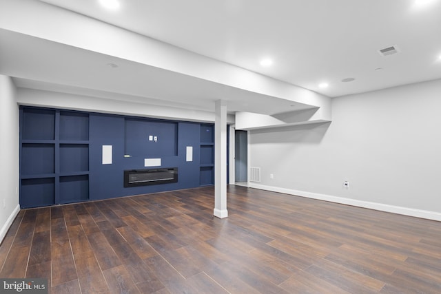 basement featuring dark hardwood / wood-style flooring