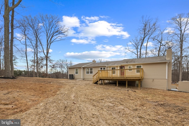 rear view of property with a deck and central air condition unit