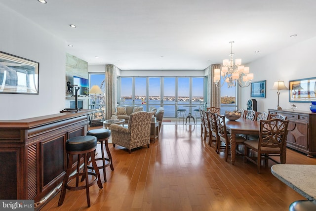 dining room with hardwood / wood-style flooring and a notable chandelier