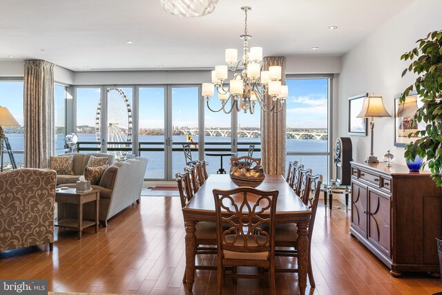 143 Waterfront St Unit 502, National Harbor, MD 20745 - dining area with healthy amount of natural light, wood finished floors, a chandelier, and a water view