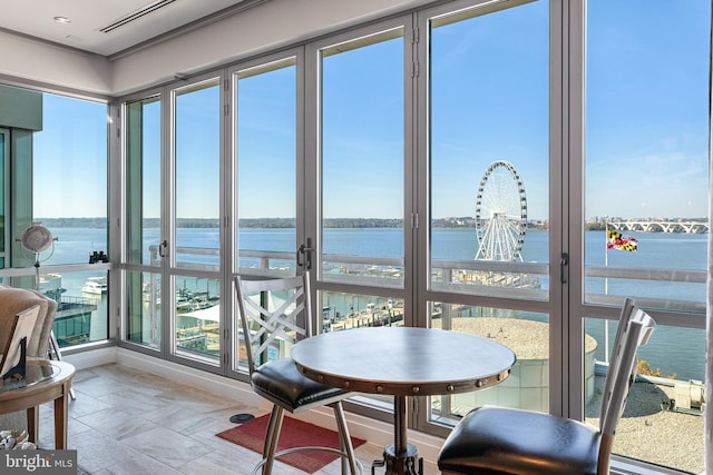 143 Waterfront St Unit 502, National Harbor, MD 20745 - sunroom with a water view, plenty of natural light, and stone finish floors