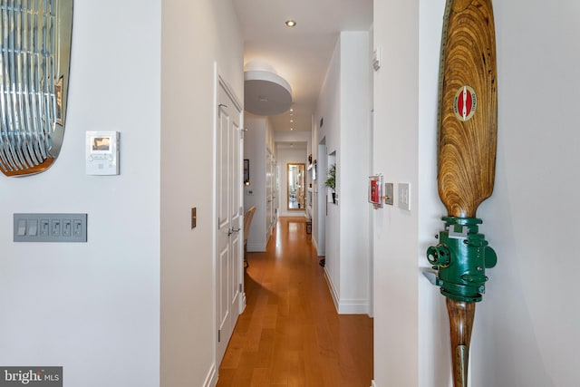 hallway with light hardwood / wood-style flooring