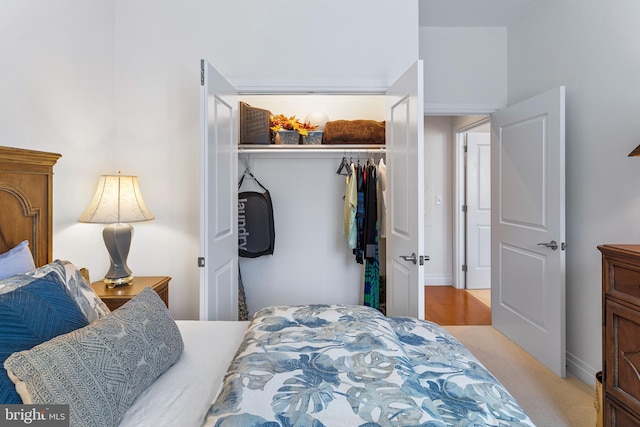 bedroom with light carpet and a closet