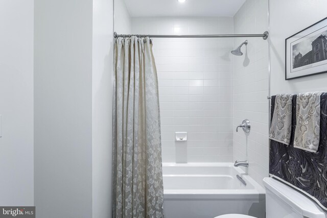 bathroom with toilet and shower / tub combo