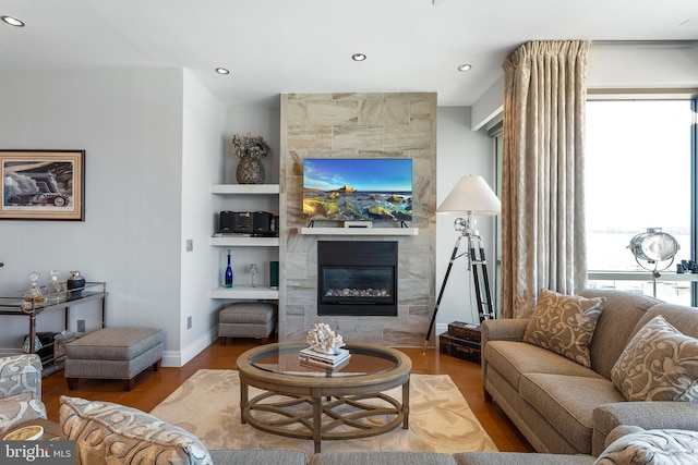 143 Waterfront St Unit 502, National Harbor, MD 20745 - living area with a tiled fireplace, wood finished floors, recessed lighting, and baseboards