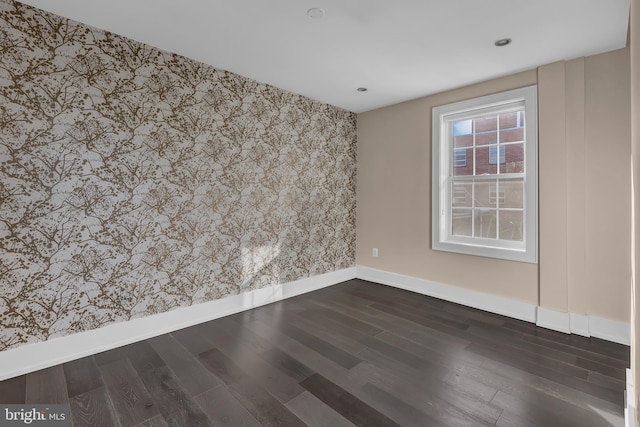 spare room featuring dark hardwood / wood-style flooring