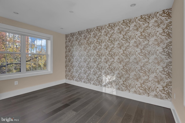 empty room with dark hardwood / wood-style floors