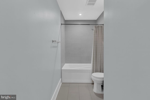 bathroom featuring tile patterned flooring, toilet, and shower / bathtub combination with curtain