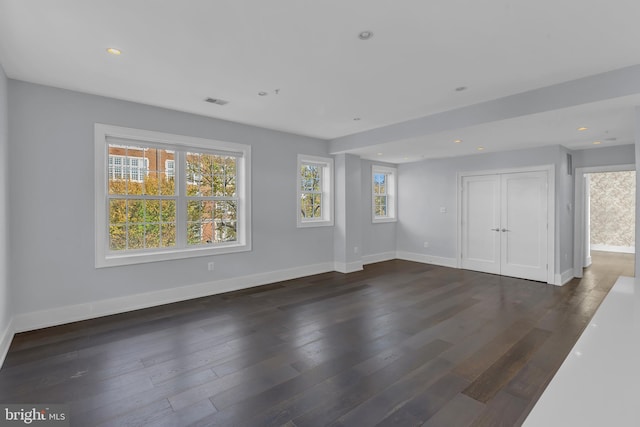 unfurnished room with visible vents, baseboards, dark wood-style flooring, and recessed lighting