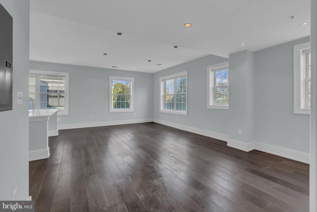 unfurnished living room with dark wood-type flooring