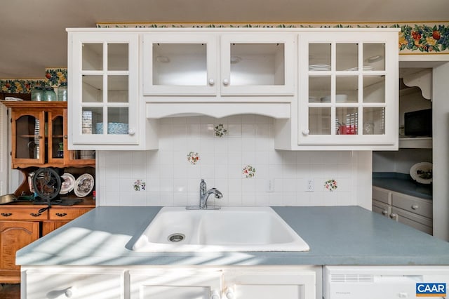 kitchen featuring white cabinetry, tasteful backsplash, and sink