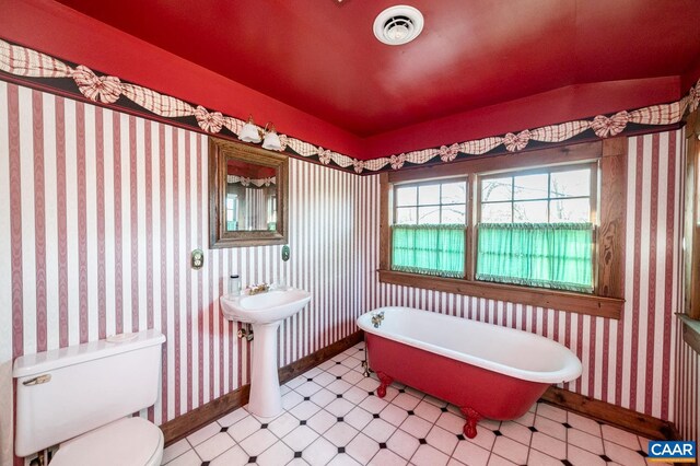 bathroom with a bath and toilet