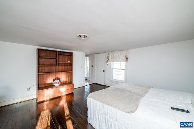 bedroom with dark hardwood / wood-style floors