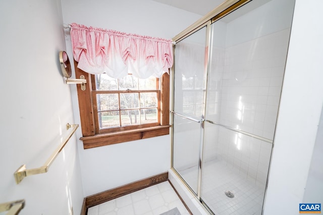 bathroom featuring a shower with door