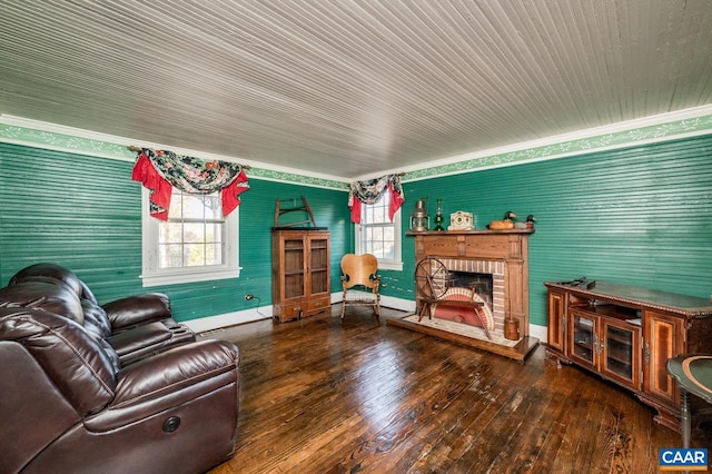 living room featuring ornamental molding, wood-type flooring, and a brick fireplace