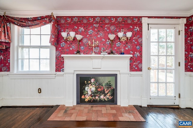 unfurnished living room featuring dark wood-type flooring and crown molding