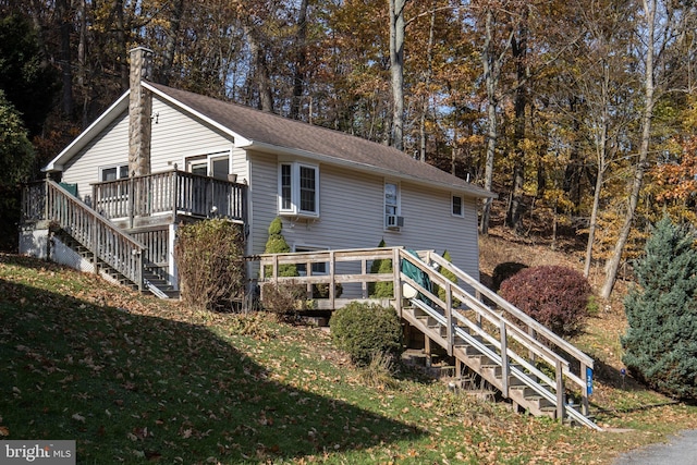 30 Sunset Ln, Catawissa, PA 17820 - rear view of house featuring a deck, a yard, stairway, cooling unit, and a shingled roof