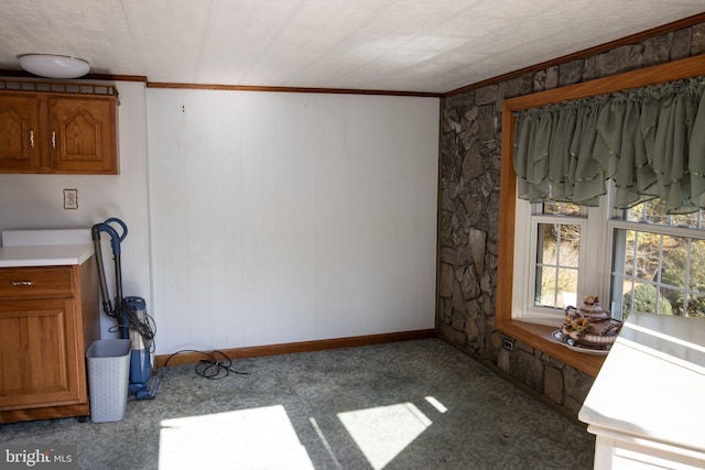 interior space with ornamental molding and light colored carpet