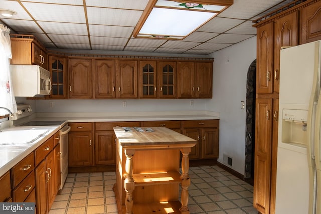 30 Sunset Ln, Catawissa, PA 17820 - kitchen with glass insert cabinets, white appliances, butcher block counters, a sink, and brown cabinets