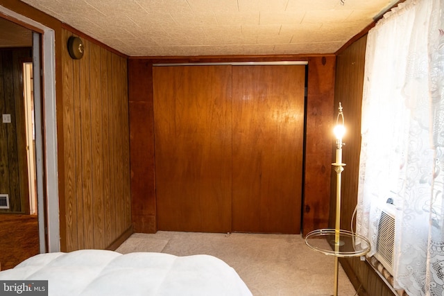 hallway with wooden walls and light colored carpet