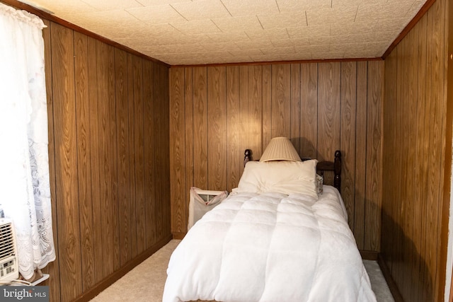 carpeted bedroom with wood walls