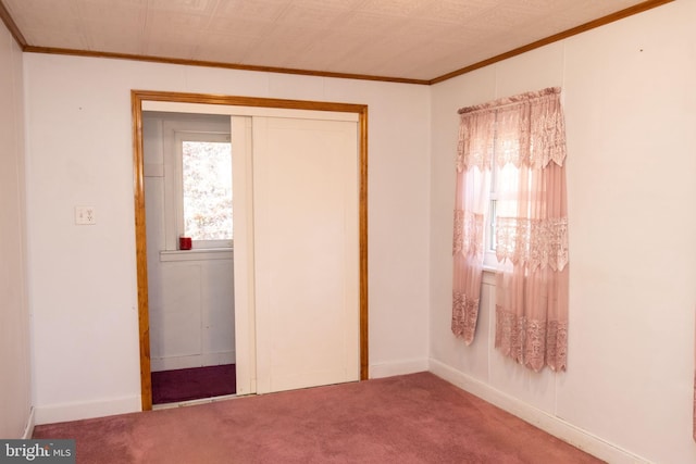 unfurnished bedroom with a closet, multiple windows, and carpet flooring