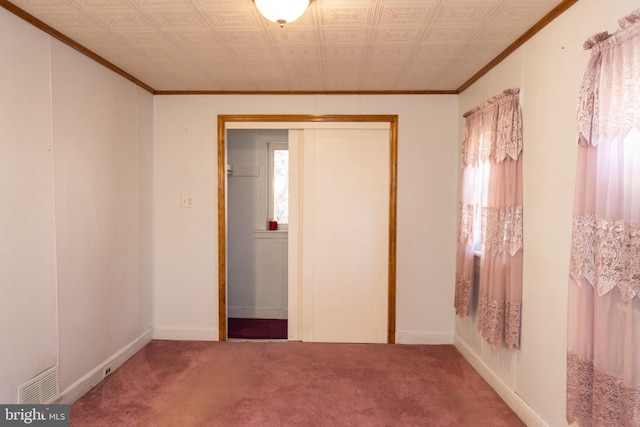 unfurnished bedroom with ornamental molding, carpet floors, and a closet