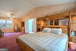 carpeted bedroom with vaulted ceiling and ceiling fan