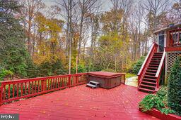 wooden deck with a hot tub