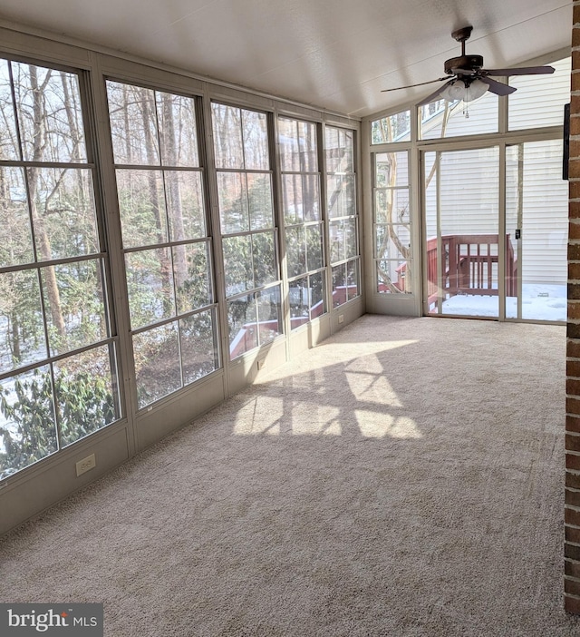 unfurnished sunroom with ceiling fan